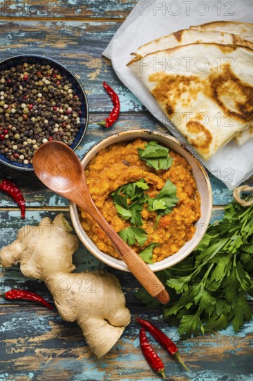 Traditional Indian lentils Dal, naan butter bread, fresh coriander. Indian Dhal spicy curry in