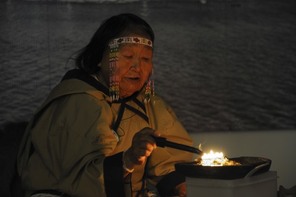 Inuit shaman burns oil at ceremony, Pond Inlet settlement, Baffin Island, Nunavut, Canada,