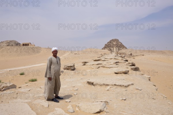 Man in front of funerary temple, pyramid of Pharaoh Sahure, Abusir, Egypt, Africa