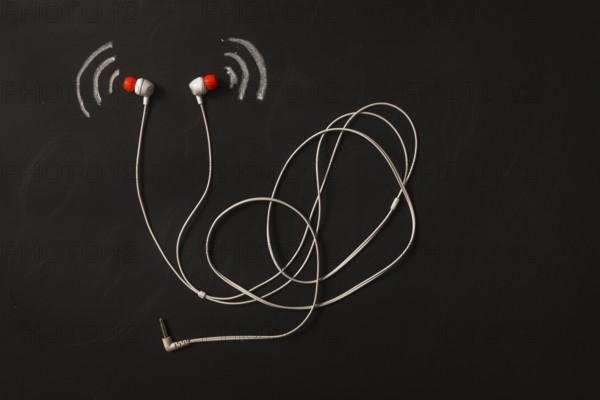 Sound wave icon near earphone blackboard. High resolution photo