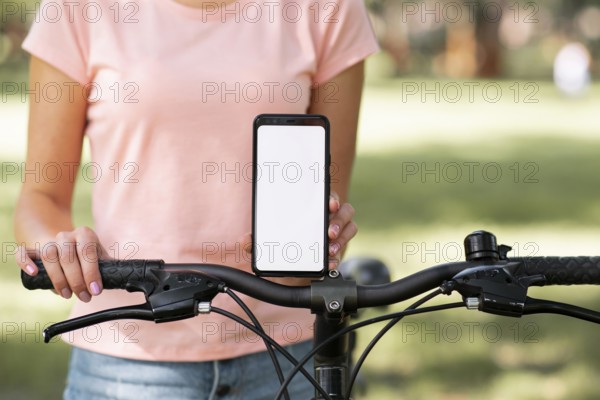 Woman with bicycle copy space mobile phone