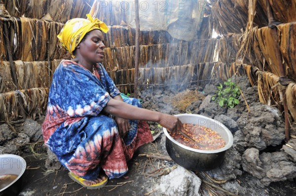 Woman cooking in tent, Mugunga 1st refugee camp, Goma, North Kivu, Democratic Republic of the Congo