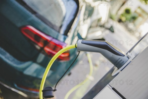 Electric car recharging with charge cable and plug leading to charge point