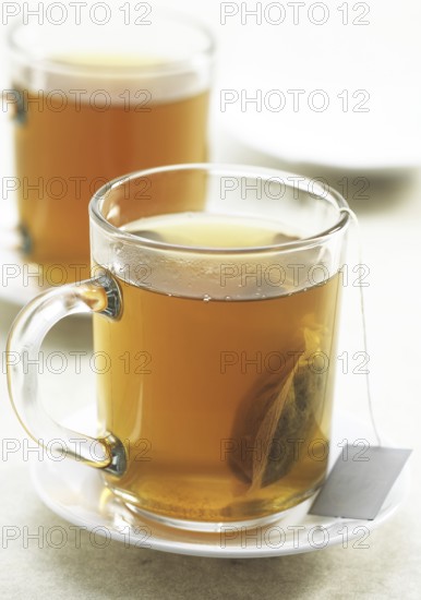Cup of green tea, infusion against white background