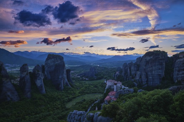 Twilight view of Meteora valley. Valley in blue shadows, clifftop Moni Agias Varvaras Roussanou