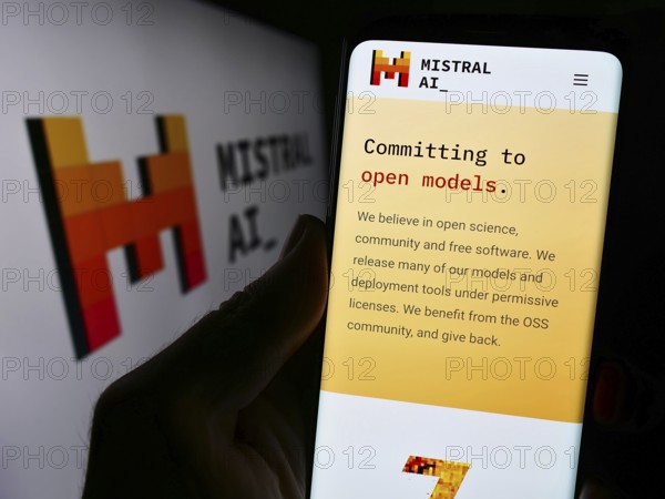 Stuttgart, Germany, 11-27-2023: Person holding cellphone with webpage of French artificial