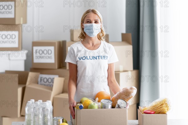 Front view female volunteer holding food donation box