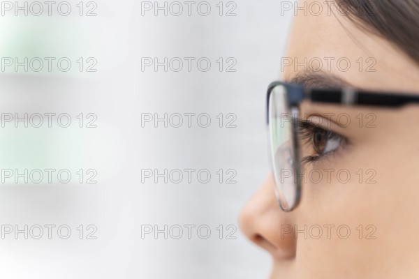 Girl store trying glasses close up