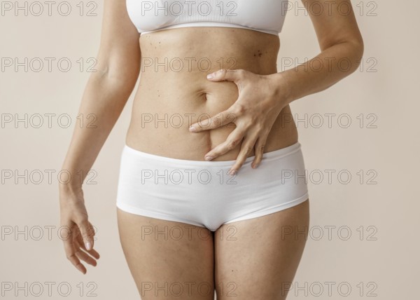 Close up hand covering belly