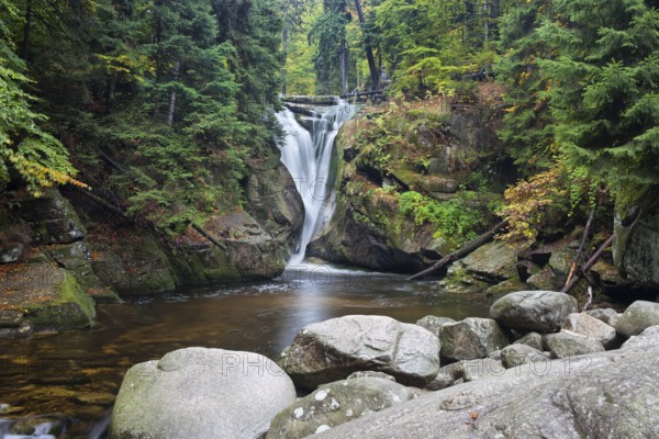 Szklarka waterfall (Polish: Wodospad Szklarki) in autumn forest, Karkonoski National Park,