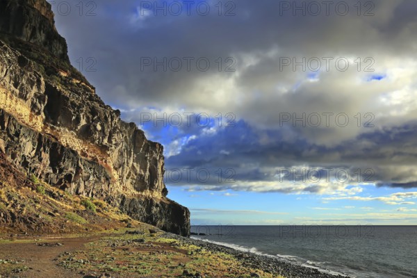 Lonely beach with cliffs on the Atlantic Ocean in the Canary Islands. Playa de Tasarte, Las Palmas,