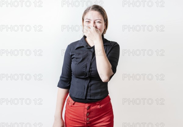 Displeased person holding her nose isolated. Disgust young girl covering nose. Woman covering nose