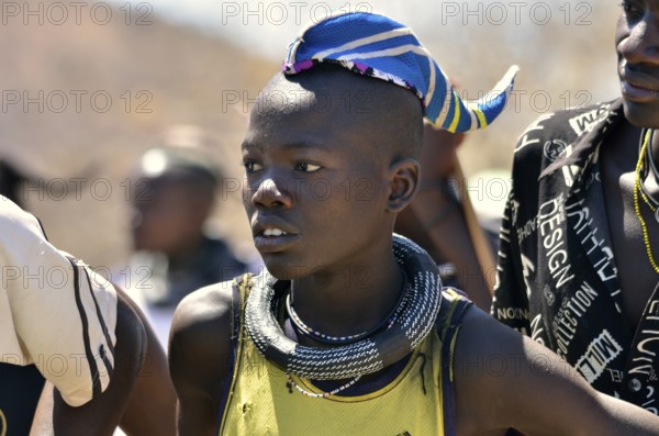 Young Himba man wearing a traditional headdress, cap in the form of a cattle horn, Omohanja,