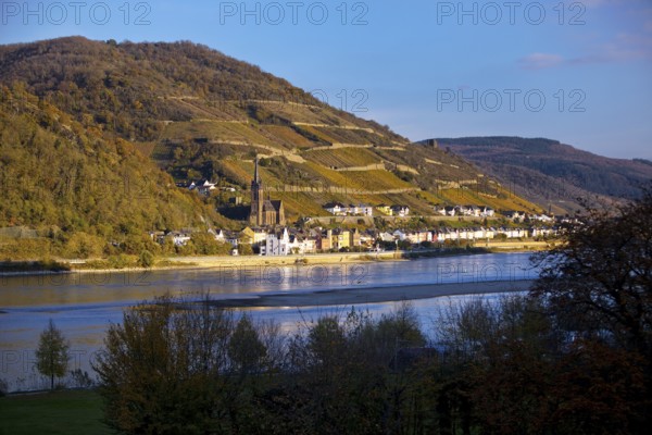 View across the Rhine in the late evening light from Bacharach to Lorch with the parish church of