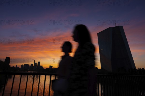 The light of the setting sun colours the sky behind the European Central Bank (ECB) and the