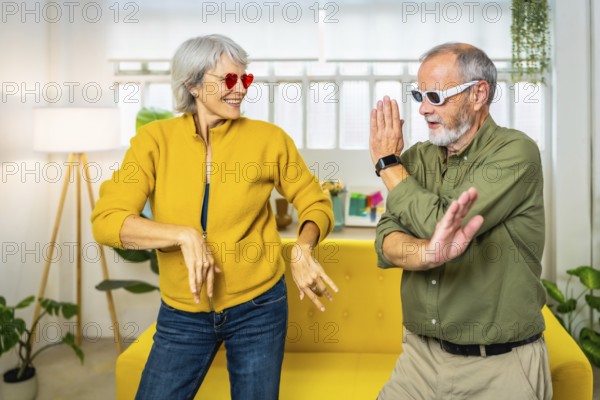 Frontal three quarter length photo of a caucasian married senior couple dancing wearing modern