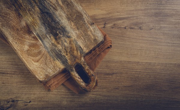 Square, chopping wooden board, chopping board with handle, on a kitchen towel, rustic style, top