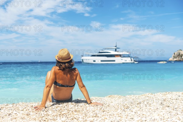 Portrait of a tourist woman sitting on Gidaki Beach on the island of Ithaki or Ithaca in the Ionian