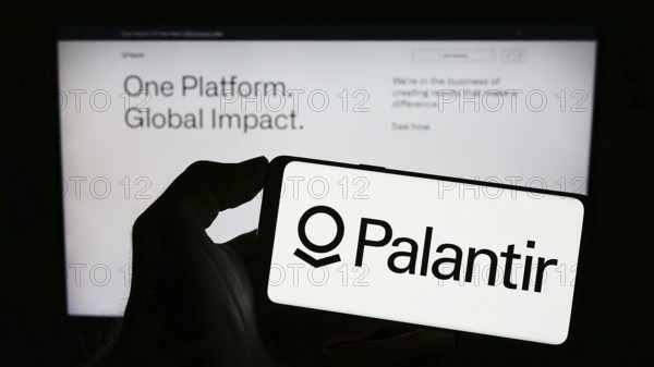 Stuttgart, Germany, 03-17-2023: Person holding cellphone with logo of US analytics company Palantir