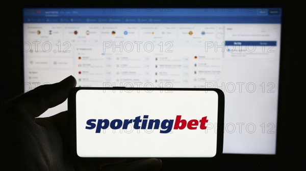 Stuttgart, Germany, 06-06-2024: Person holding cellphone with logo of British sports betting