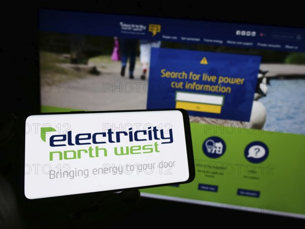 Stuttgart, Germany, 10-28-2023: Person holding mobile phone with logo of British energy company