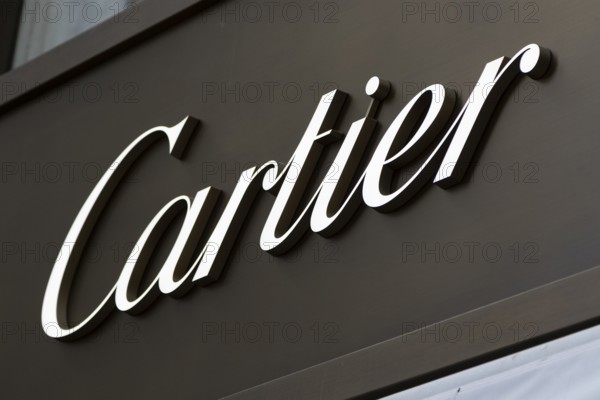 Close-up, logo of the French luxury fashion brand Cartier for jewellery and watches on a boutique