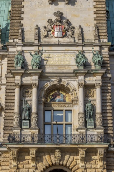 Detail facade Hamburg City Hall with city coat of arms, windows, sculptures and rich decorations on