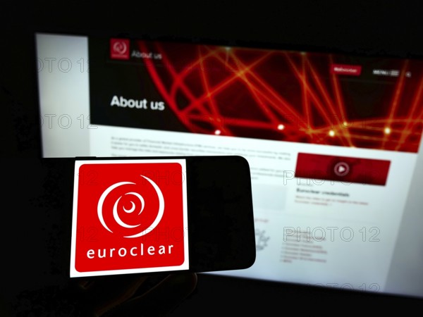 Stuttgart, Germany, 01-06-2022: Person holding mobile phone with logo of Belgian financial company