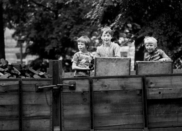 14/03/1982 GDR East Berlin district of Prenzlauer Berg. Three boys playing on a parked coal wagon