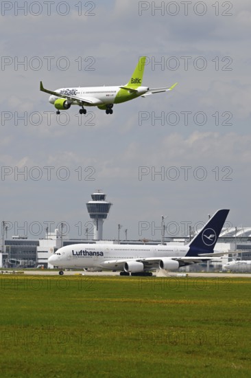 Lufthansa Airbus A380-800 with control tower waiting for take-off clearance for southern runway
