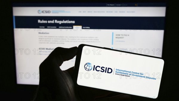Stuttgart, Germany, 08-05-2023: Person holding cellphone with logo of World Bank's institution