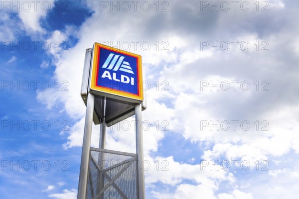 Hockenheim, Germany - June 08, 2022: Commercial sign of ALDI Store against a blue sky. ALDI is a