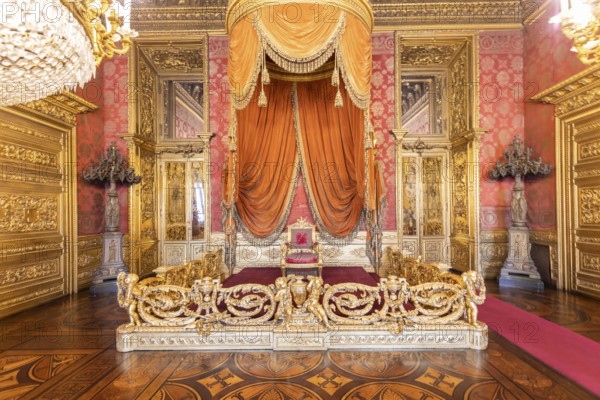 Turin, Italy - Circa August 2021: old throne room interior with chair in luxury palace. Red and