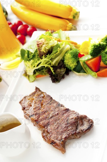Juicy BBQ grilled rib eye, ribeye steak, vegetables and lagher beer on background, MORE DELICIOUS