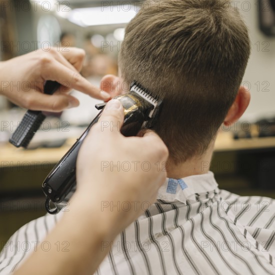 Back view man getting haircut