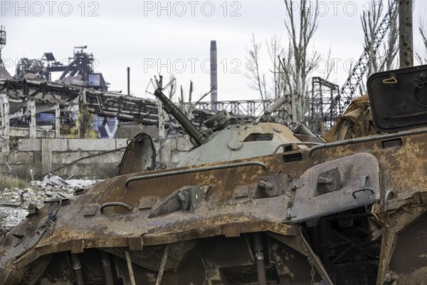 Burnt tank and destroyed buildings of the Azovstal plant shop in Mariupol war in Ukraine with