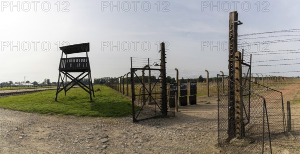 Auschwitz, Poland - 15 September, 2021: guard tower and prison camp gate at Auschwitz concentration