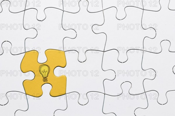 Idea icon yellow puzzle piece connected with white grid puzzle backdrop. Resolution and high