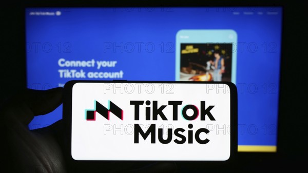 Stuttgart, Germany, 07-30-2023: Person holding cellphone with logo of streaming service TikTok