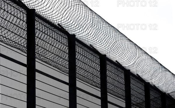 High fence and barbed wire, concertina wire, Nato barbed wire at Mainkofen District Hospital,
