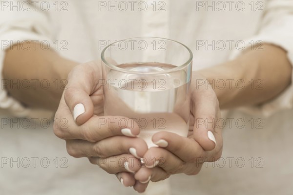 Woman holding glass filled with water. Resolution and high quality beautiful photo