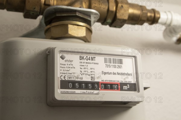 Symbolic image of energy costs in the household, natural gas, analogue gas meter in a flat,