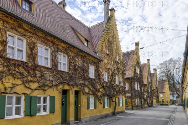 Building in the historic Fuggerei residential complex in the old town of Augsburg, Augsburg,