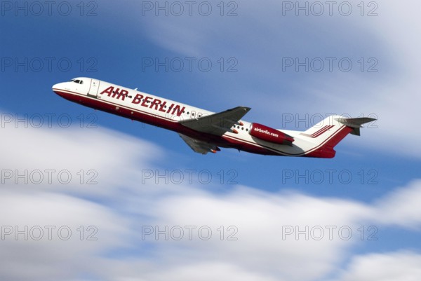 Airplane of Airline Air Berlin, takeoff, with blue sky and white clouds, motion blur showing speed