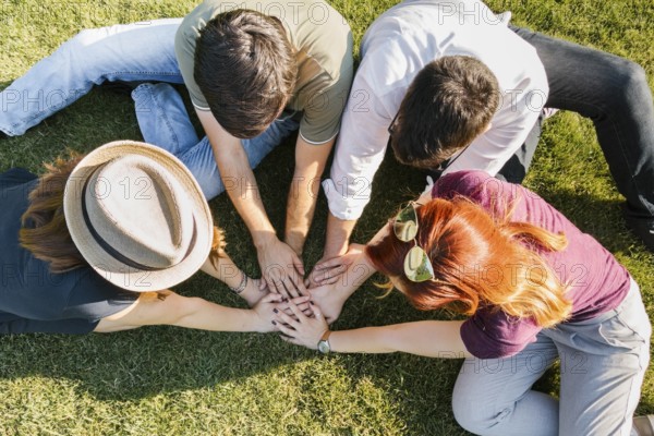 group adult friends putting hands together