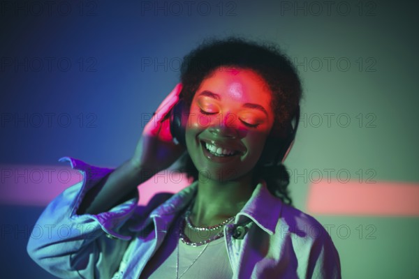 Young happy african american woman in black headphones listening to music, enjoying high quality