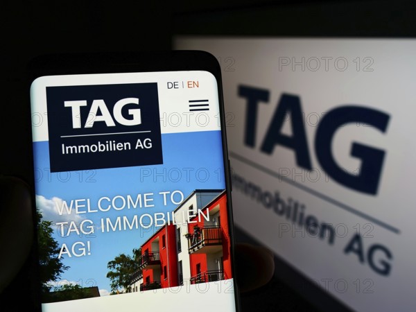 Stuttgart, Germany, 05-21-2022: Person holding smartphone with website of German real estate