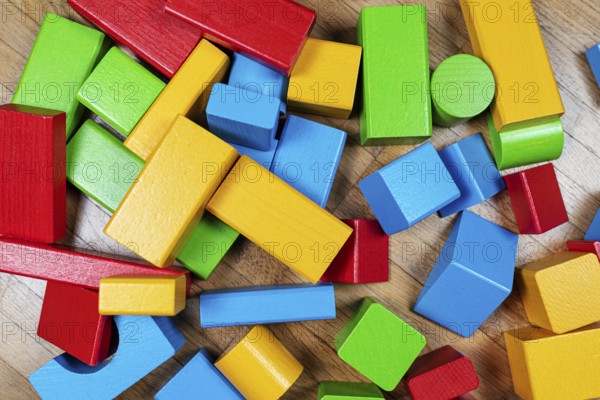 above view of colorful wooden toy blocks on hardwood floor