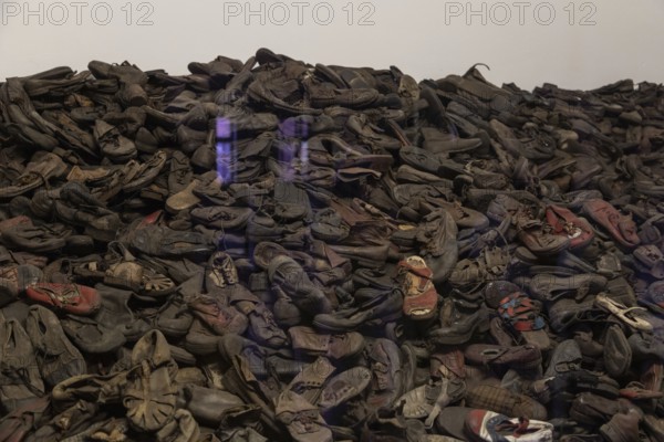 A picture of an exhibit inside the Memorial and Museum Auschwitz I that shows a collection of shoes