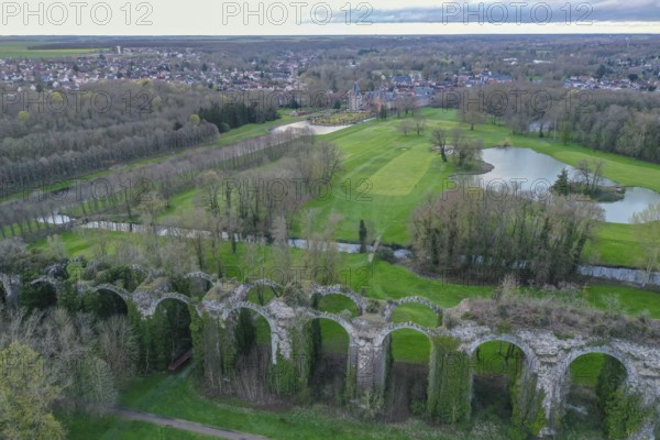 Aerial view of Chateau de Maintenon on the Eure river with golf course and ruins of the aqueduct,
